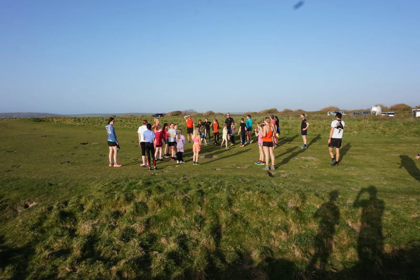 Families in a circle for a session on the downs
