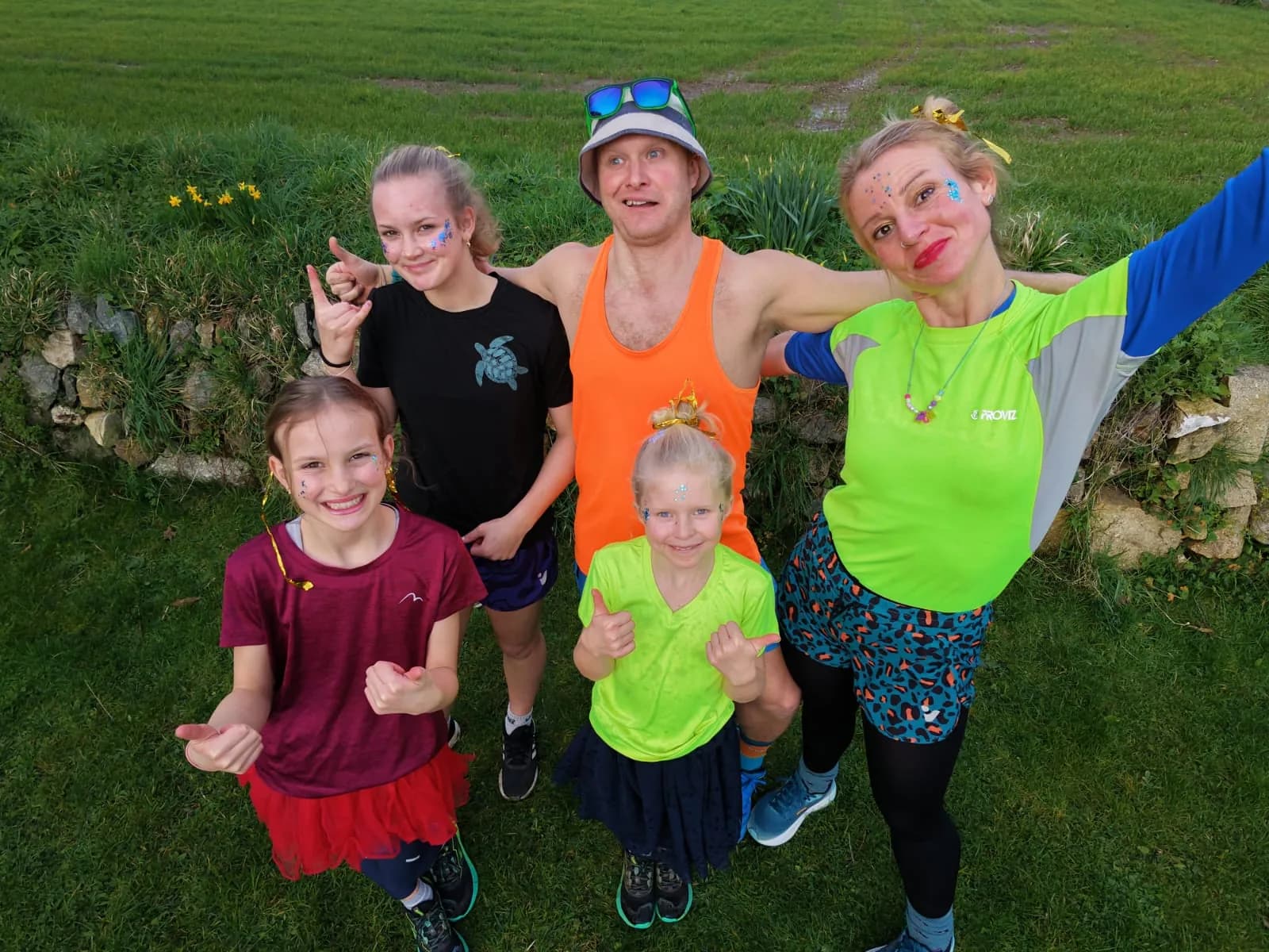 The family of five in neon face paint and glow gear, ready for a rave run