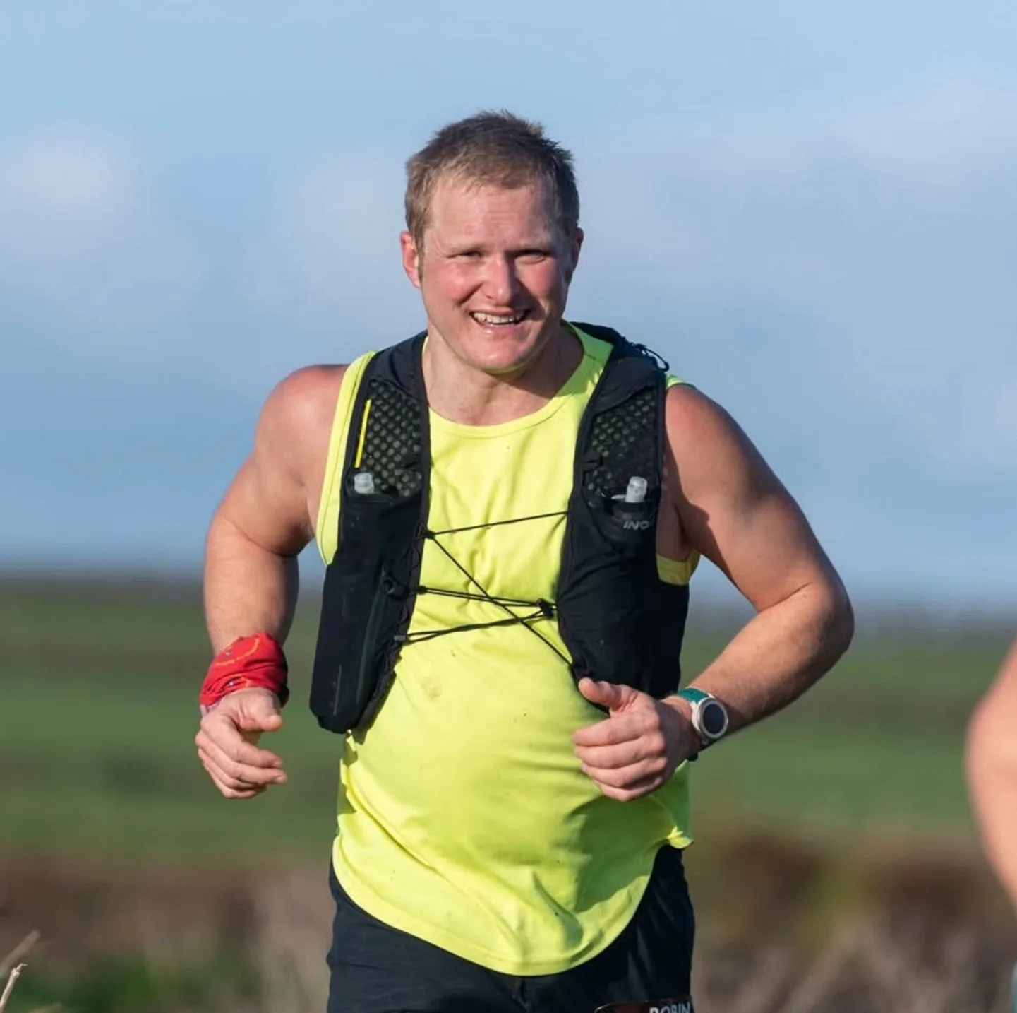 Robin mid-stride on a run, grinning